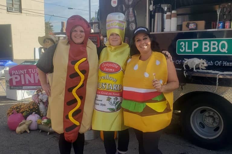 Three Little Piggies staff members dressed as a hotdog, burger, and mustard for Halloween